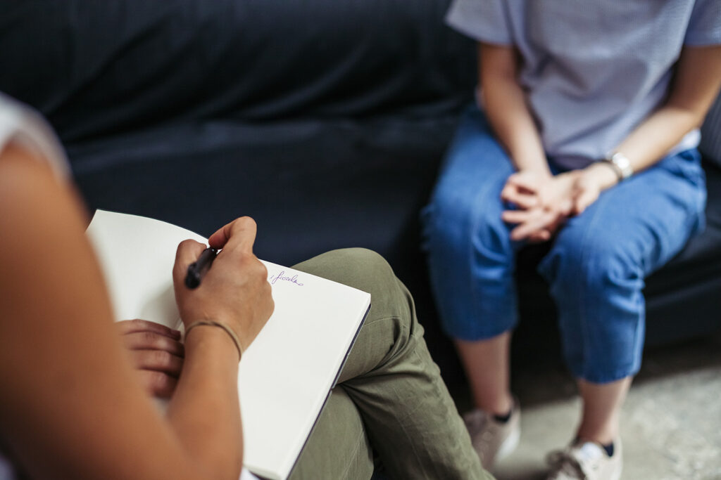 Psychotherapy session, patient talking with therapist about their mental health