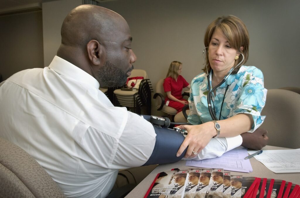 Doctor taking a man's blood pressure
